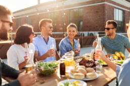 friends enjoying a roof top meal uai
