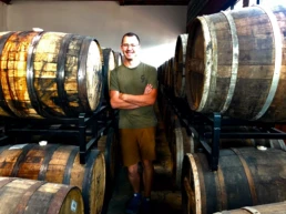 Co-founder of Cerebral Brewing standing in front of barrels